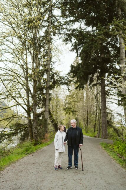 Elim Village residents hold hands while walking along the Vedder River Trail