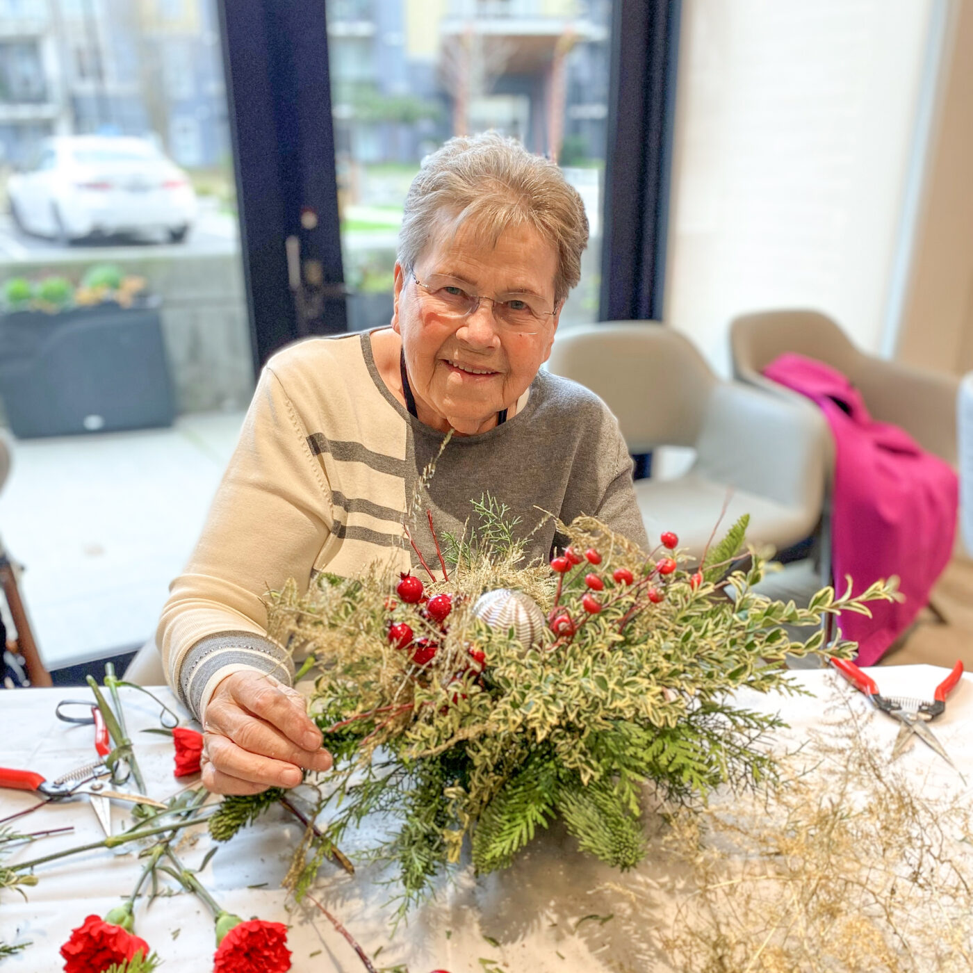 Elim Village Garrison Crossing resident working on a Christmas centrepiece display